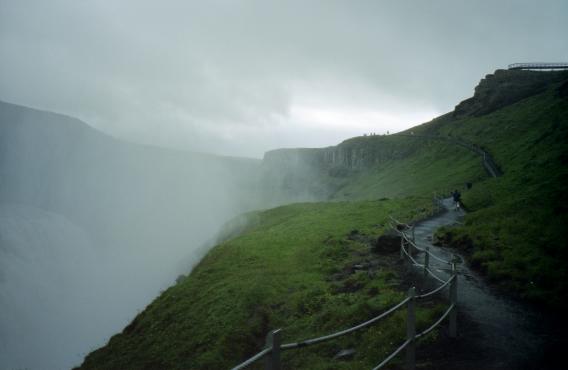 A view up the pathway showing the mist produced by the waterfall