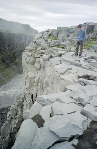 Gordon standing near the edge, which has crumbled away over time
