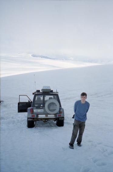 Gordon standing by the jeep on the glacier