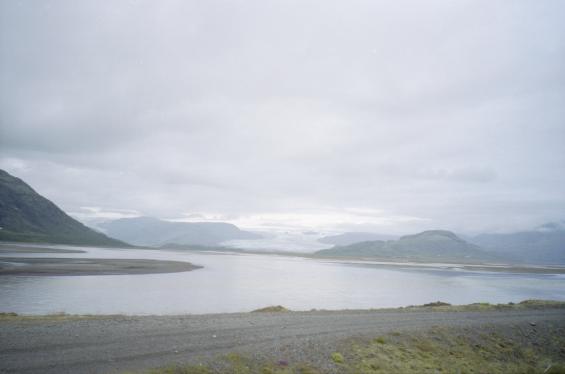 A view from the road over the water to a glacier tongue